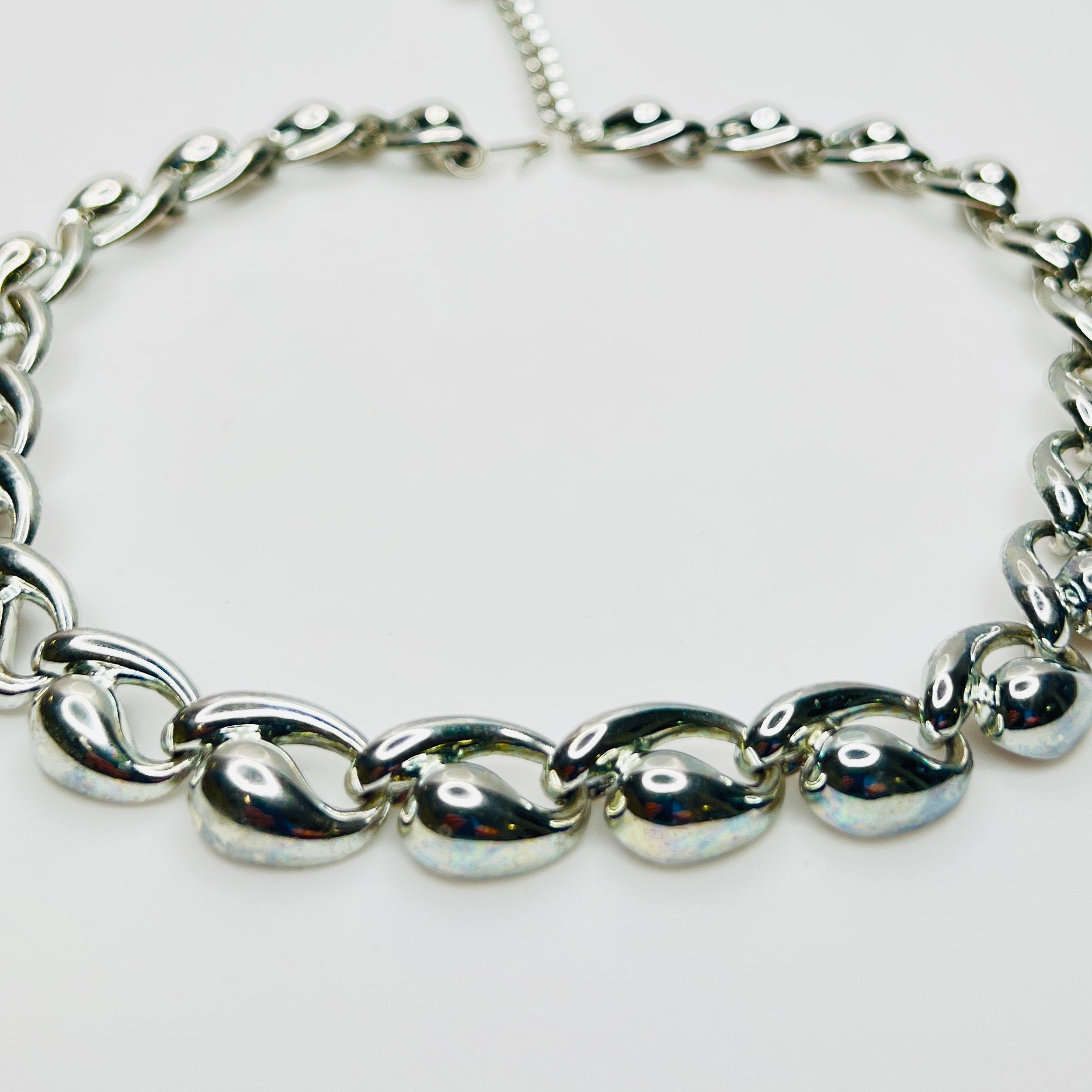 Close up detail of vintage mid century silver sculptural links