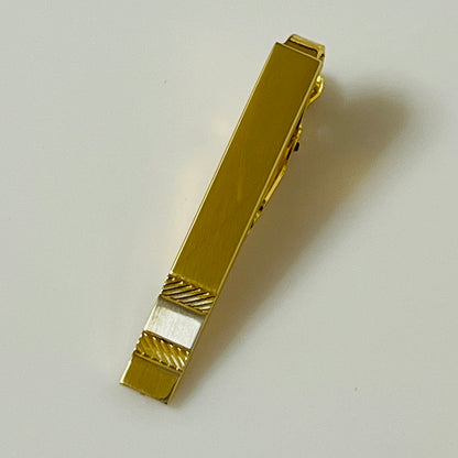Mid-century gold and silver tone tie clip with minimalist stripe accents