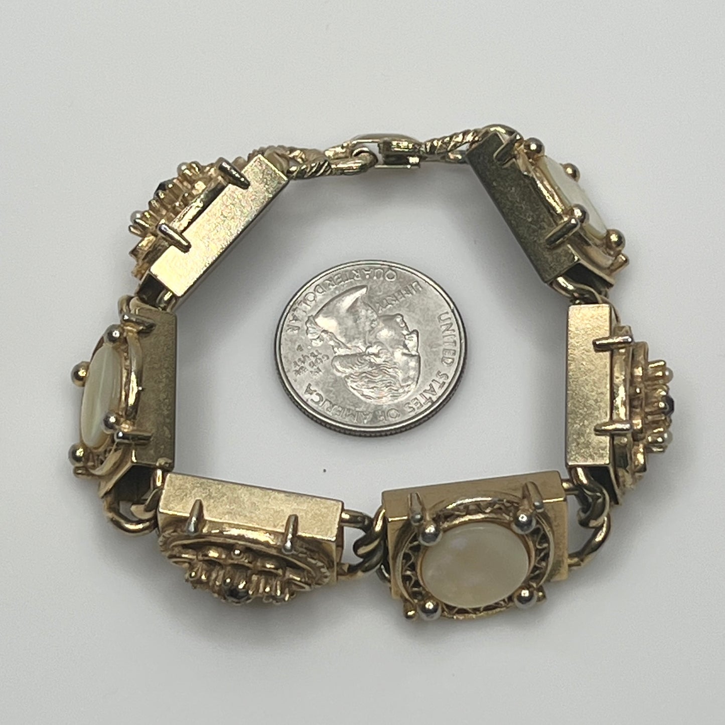 Ornate vintage gold link bracelet with hinged clasp and purple rhinestones