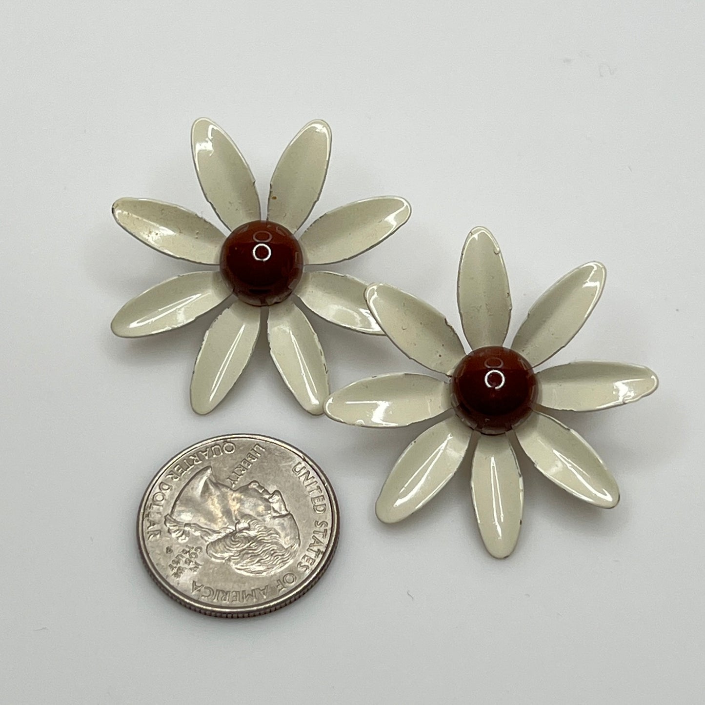Clip-on enamel daisy earrings with white petals and brown centers
