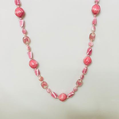 1960s pink glass bead necklace with swirled and faceted shapes in assorted pastel tones