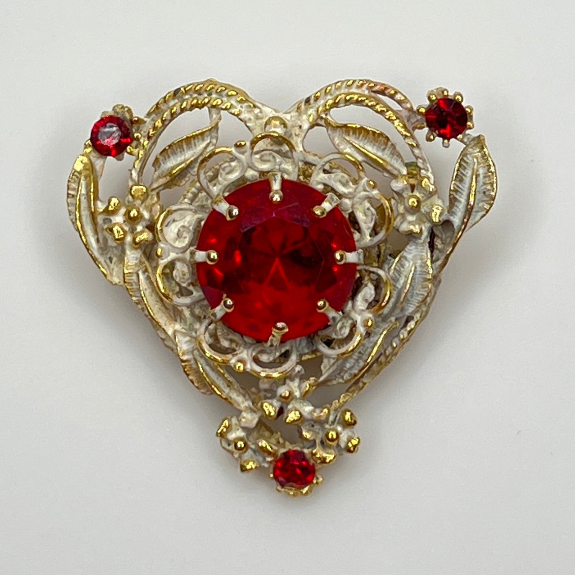 1960s heart-shaped brooch with red rhinestone and white enamel