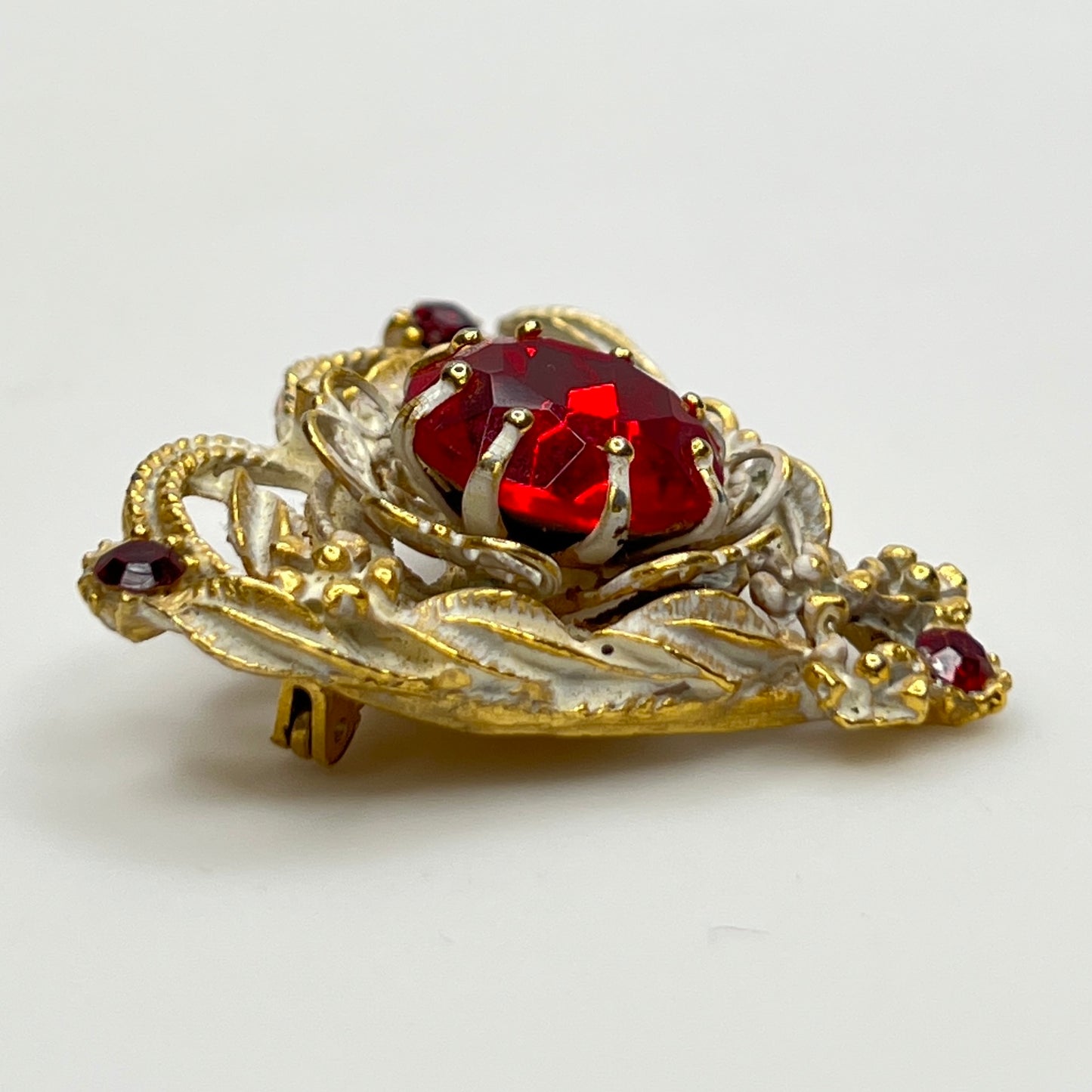 1960s heart-shaped brooch with red rhinestone and white enamel