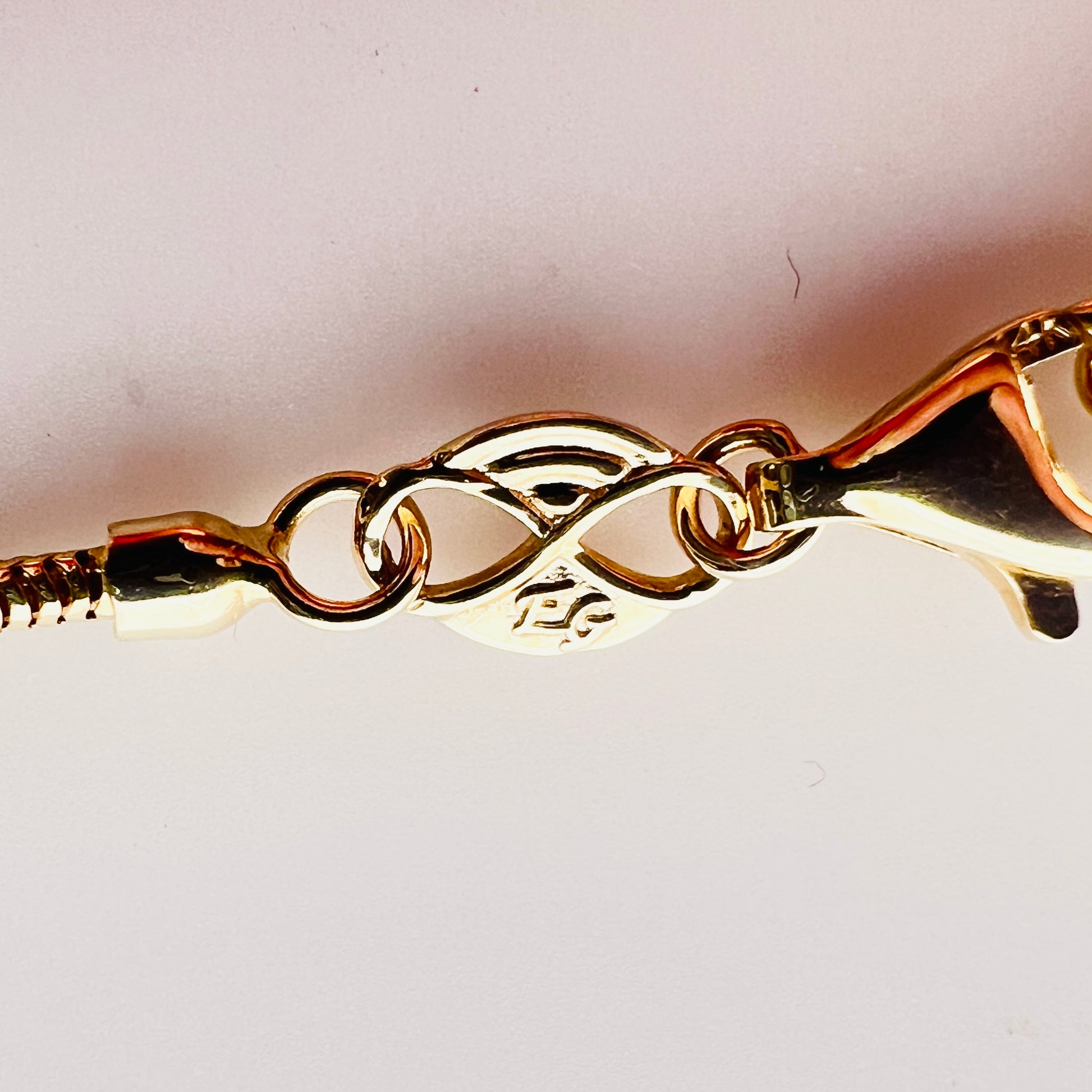 Close-up of 14K Italy clasp and snake chain detail