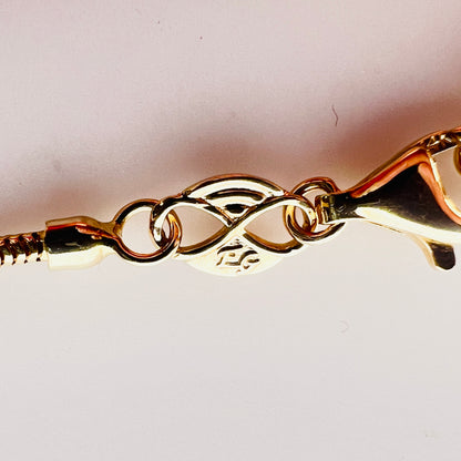 Close-up of 14K Italy clasp and snake chain detail