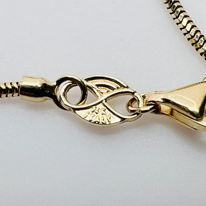 Close-up of 14K Italy clasp and snake chain detail