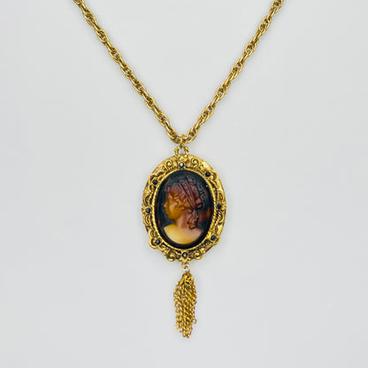 Gold tone glass cameo locket necklace with tassel drop