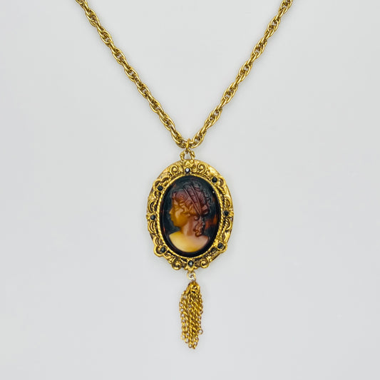 Gold tone glass cameo locket necklace with tassel drop
