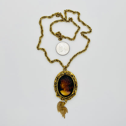 Gold tone glass cameo locket necklace with tassel drop
