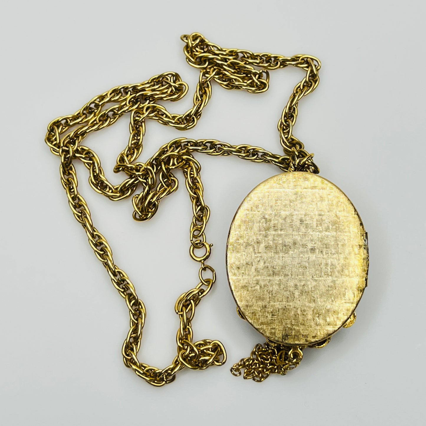 Gold tone glass cameo locket necklace with tassel drop
