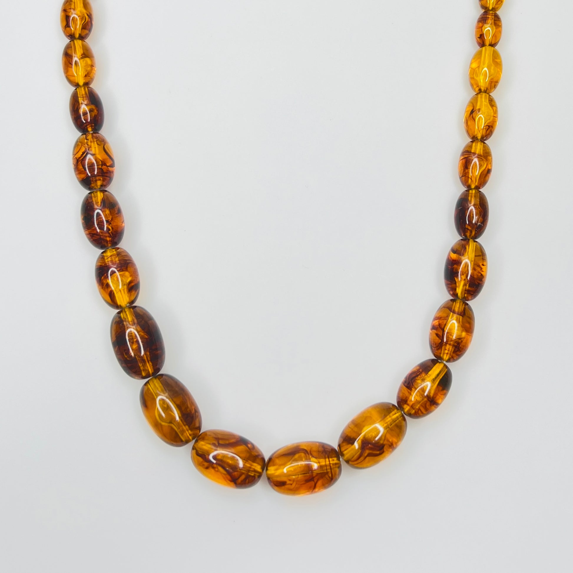 Marbled amber Lucite bead necklace with warm honey tones
