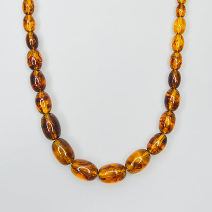 Marbled amber Lucite bead necklace with warm honey tones