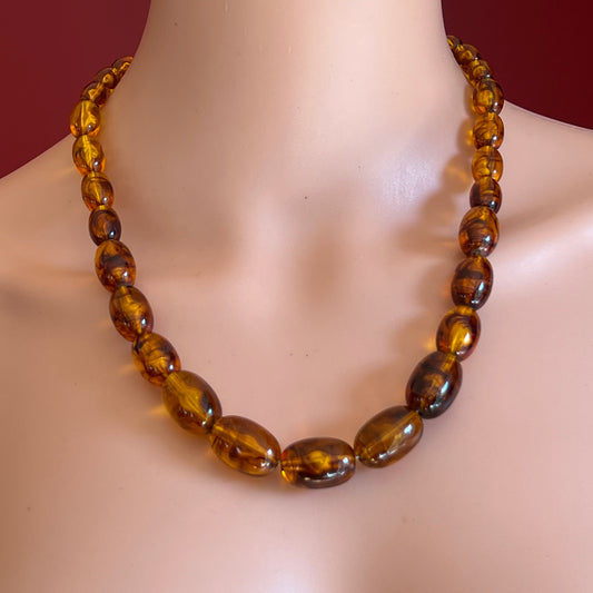 Marbled amber Lucite bead necklace with warm honey tones