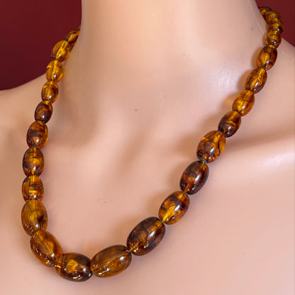 1950s gold-tone clasp necklace with oval Lucite beads