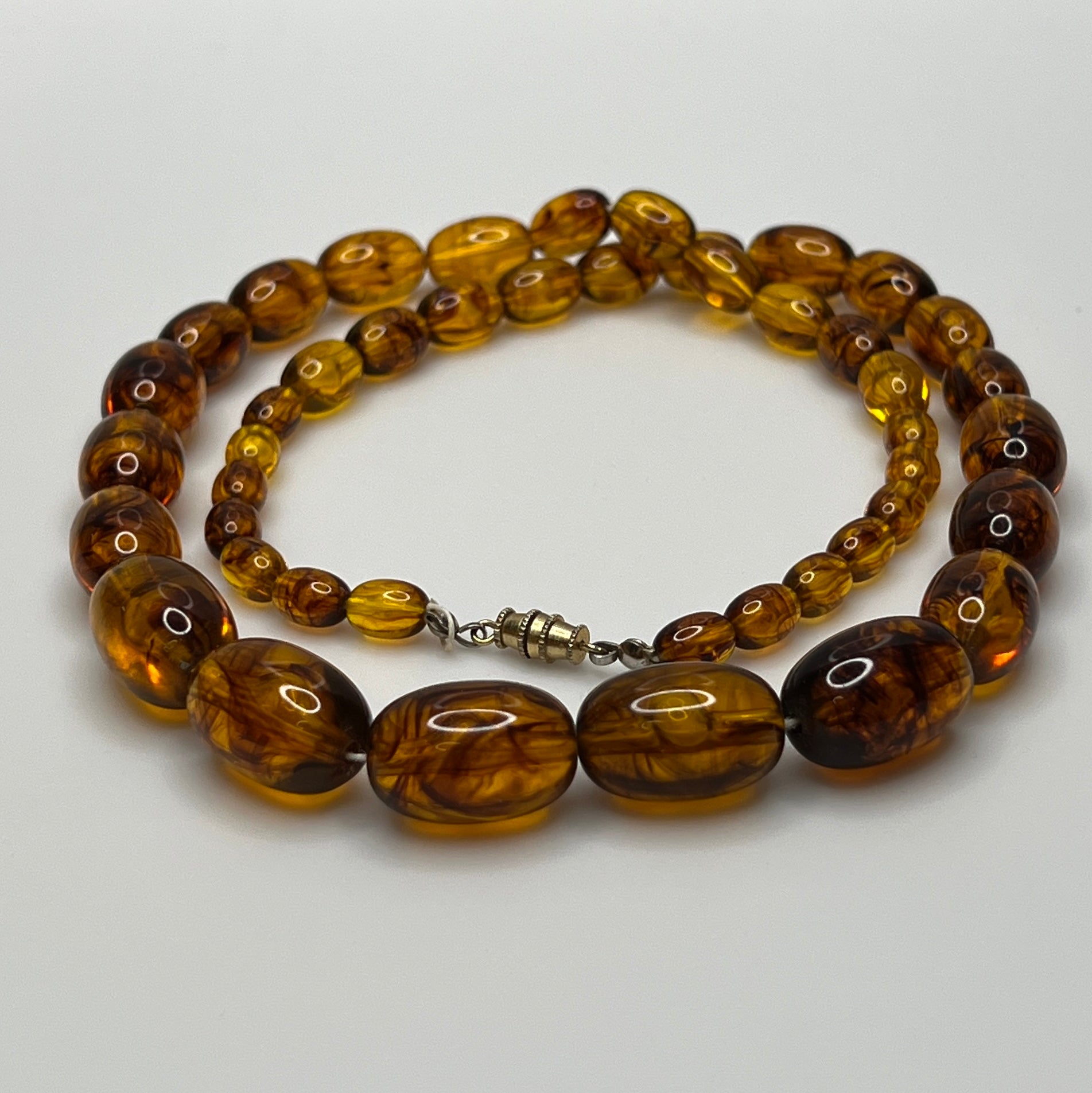 Marbled amber Lucite bead necklace with warm honey tones