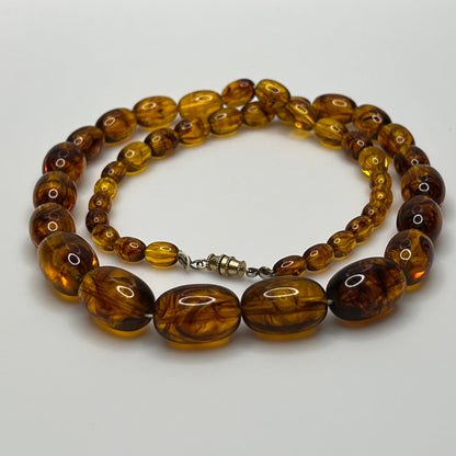 Marbled amber Lucite bead necklace with warm honey tones