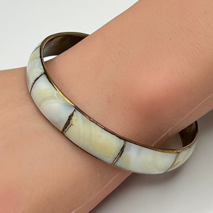 1970s brass and mother of pearl bangle bracelet on wrist