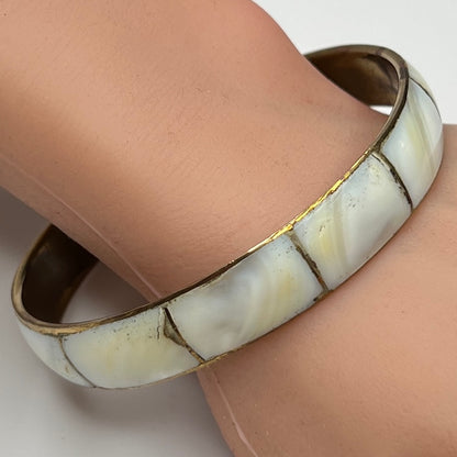 1970s brass and mother of pearl bangle bracelet on wrist