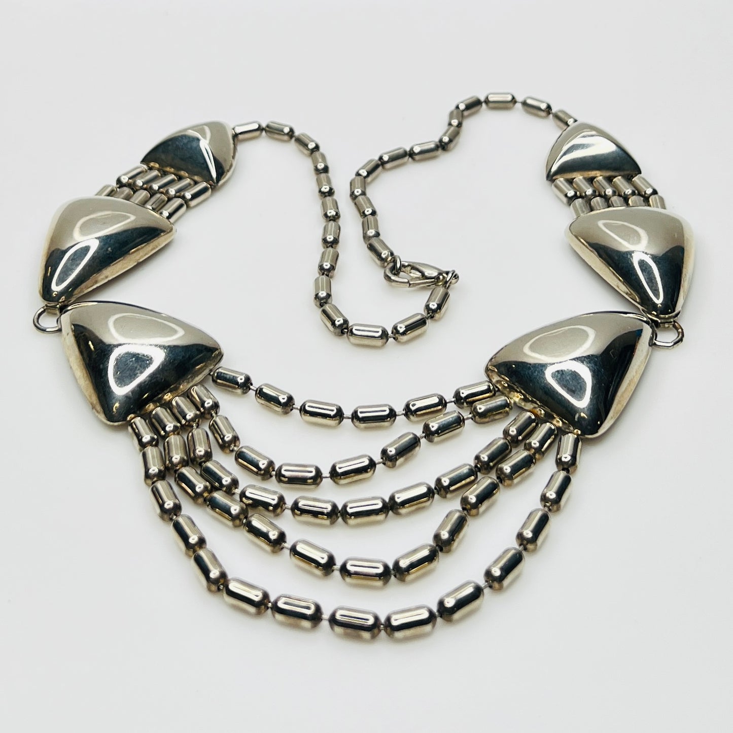 1970s silver tone geometric necklace with triangular links and cascading chains