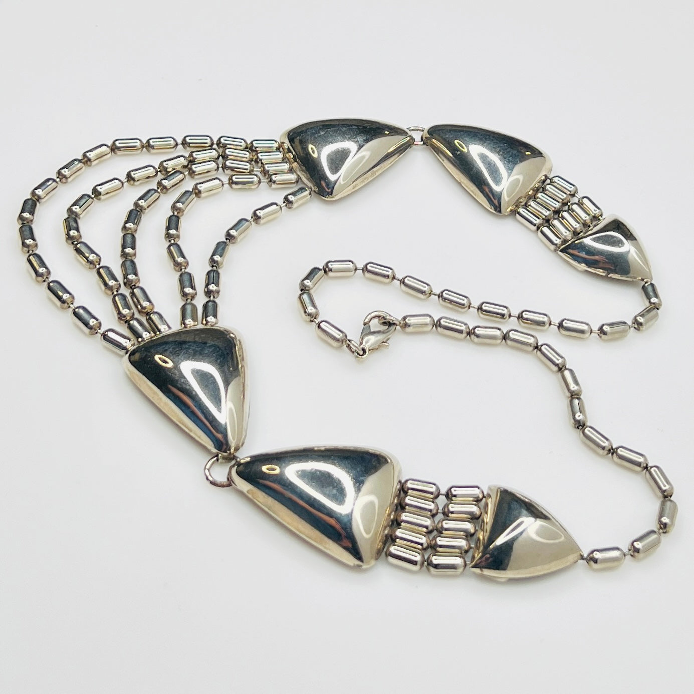 1970s silver tone geometric necklace with triangular links and cascading chains