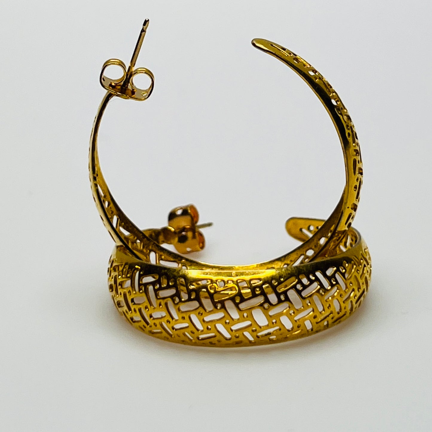 Pair of vintage gold woven statement earrings, close-up