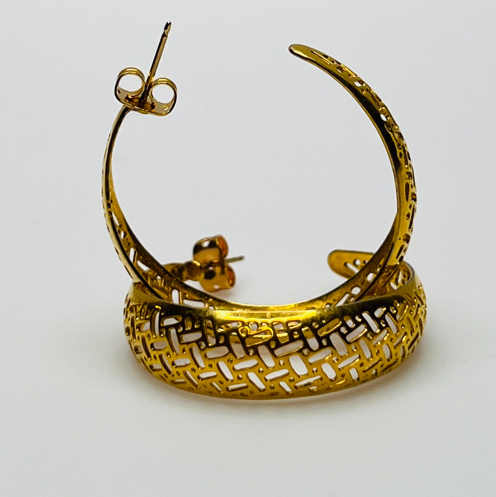 Pair of vintage gold woven statement earrings, close-up