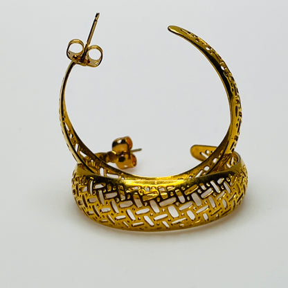 Pair of vintage gold woven statement earrings, close-up