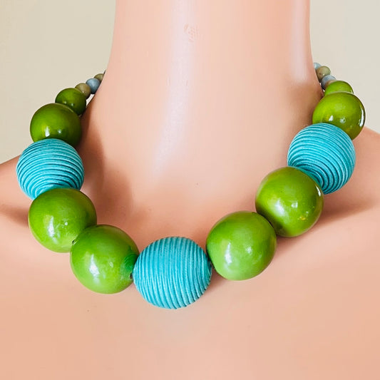 Bold 1980s green and blue beaded statement necklace on mannequin