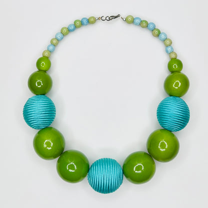 Flat lay of wood and ceramic bead necklace with hook clasp