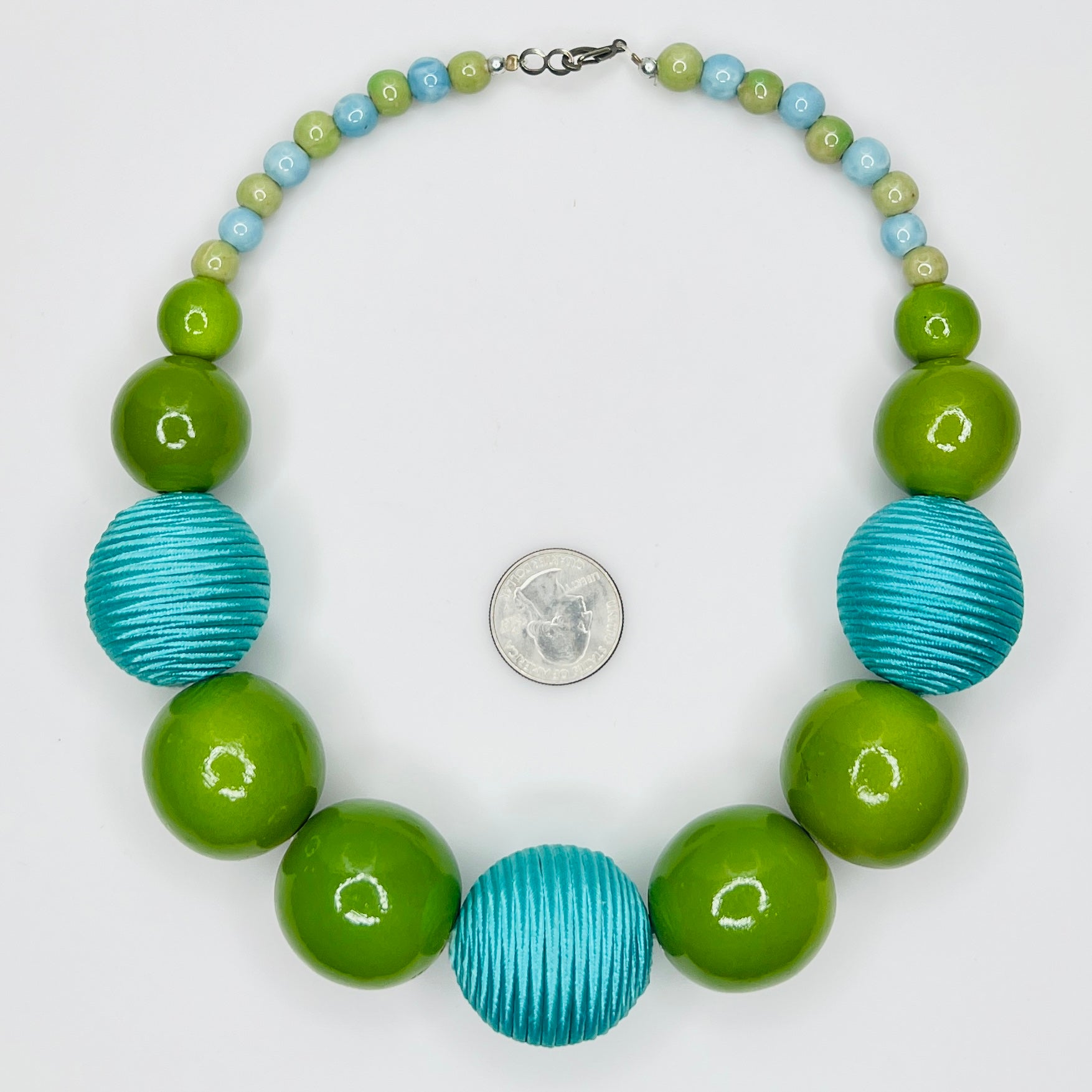 Flat lay of wood and ceramic bead necklace with hook clasp