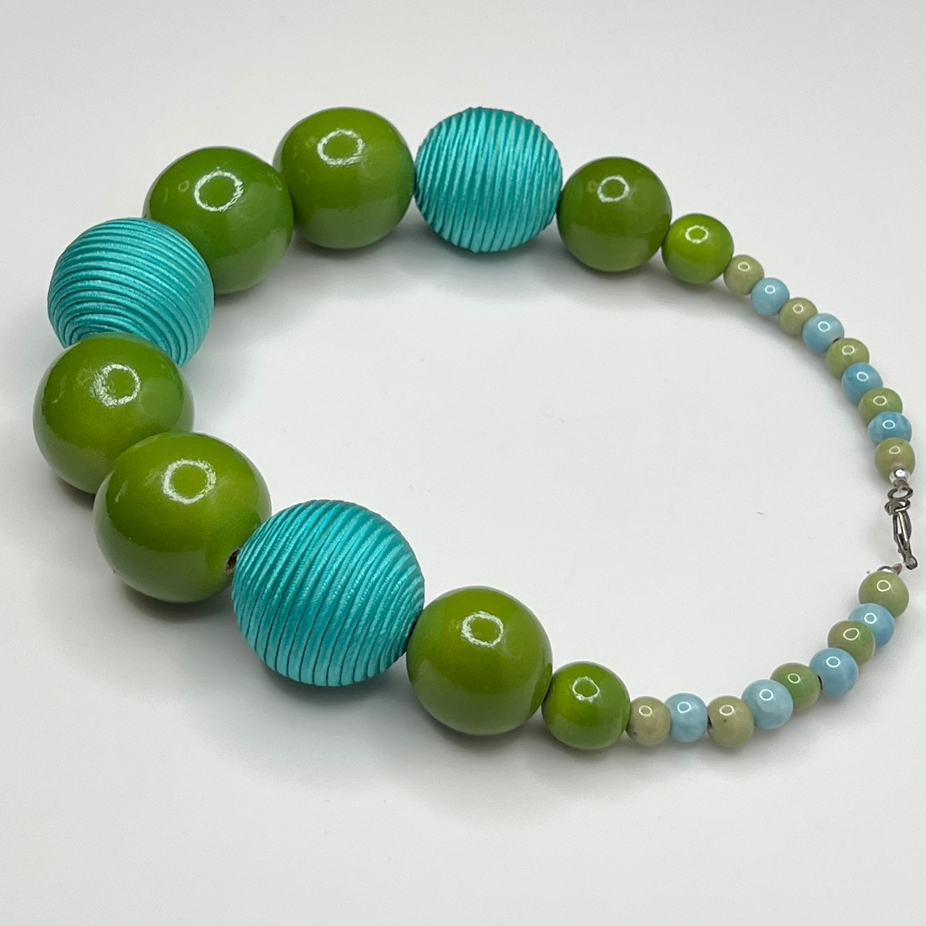 Flat lay of wood and ceramic bead necklace with hook clasp