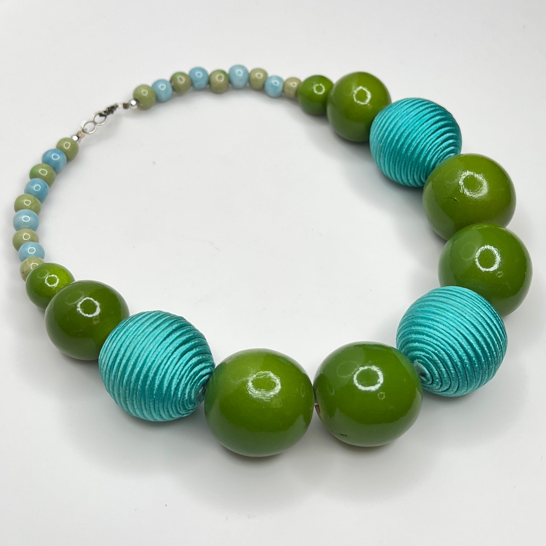 Flat lay of wood and ceramic bead necklace with hook clasp