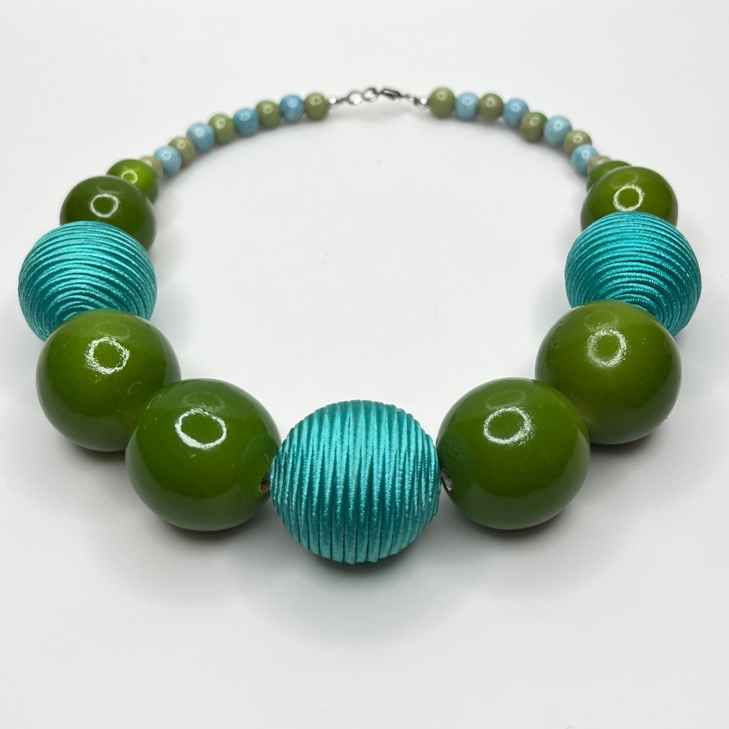 Flat lay of wood and ceramic bead necklace with hook clasp