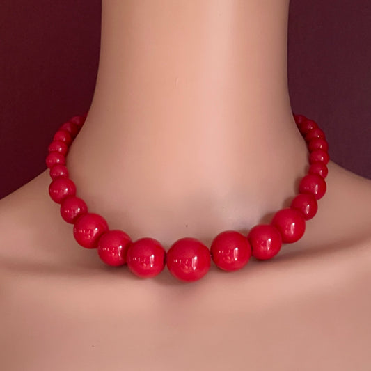 Vintage red bubblegum bead necklace on mannequin, chunky acrylic collar