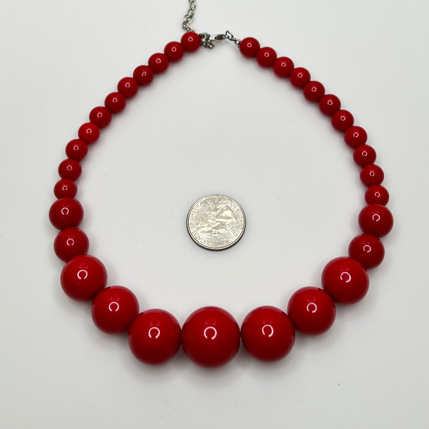Close-up of 1980s candy apple red graduated bead necklace, 16-inch length