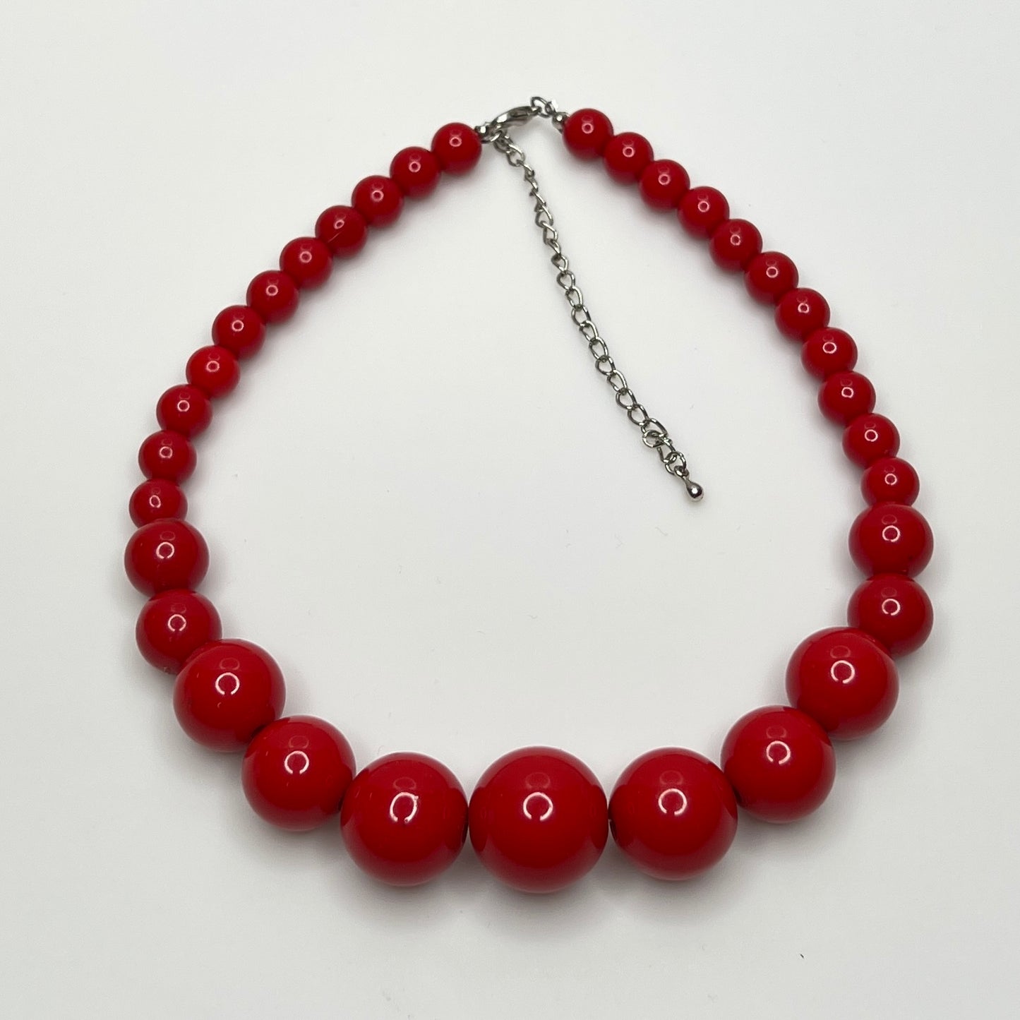 Close-up of 1980s candy apple red graduated bead necklace, 16-inch length