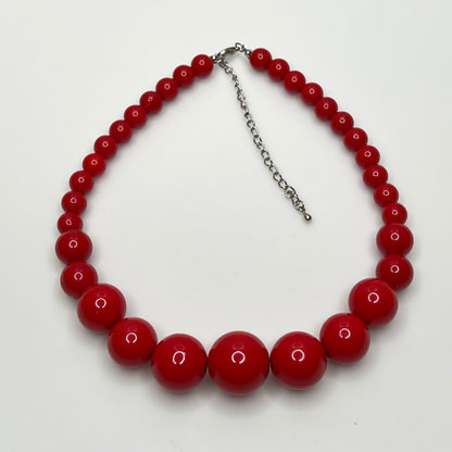 Close-up of 1980s candy apple red graduated bead necklace, 16-inch length