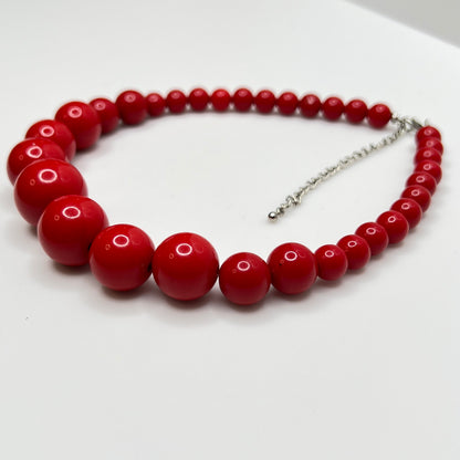 Glossy red beaded necklace with extender chain and lobster clasp