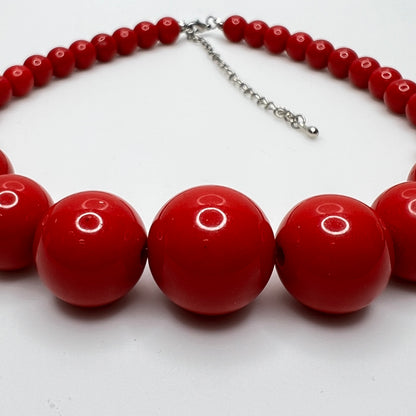 Glossy red beaded necklace with extender chain and lobster clasp