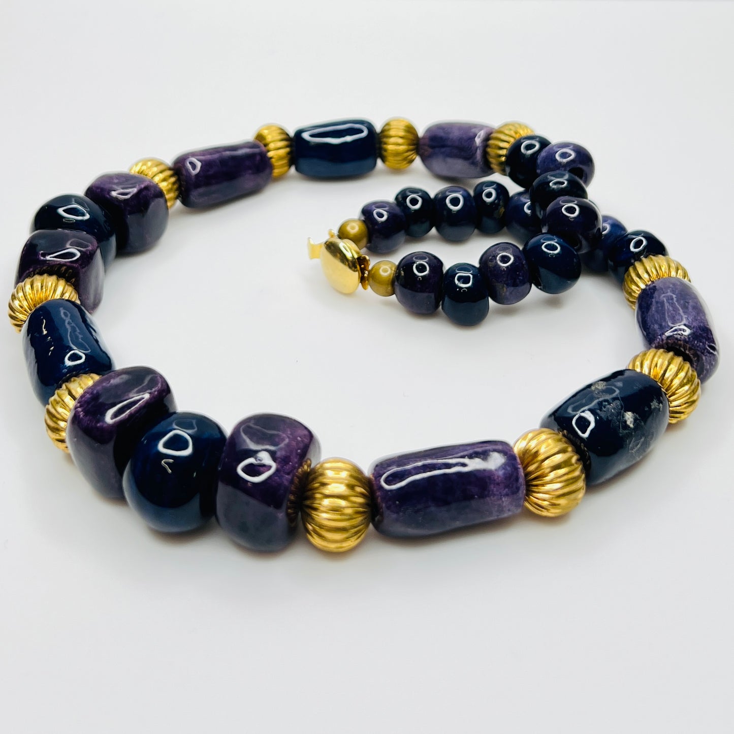 Close-up of gold tone box clasp and glossy ceramic beads, 21 inch necklace