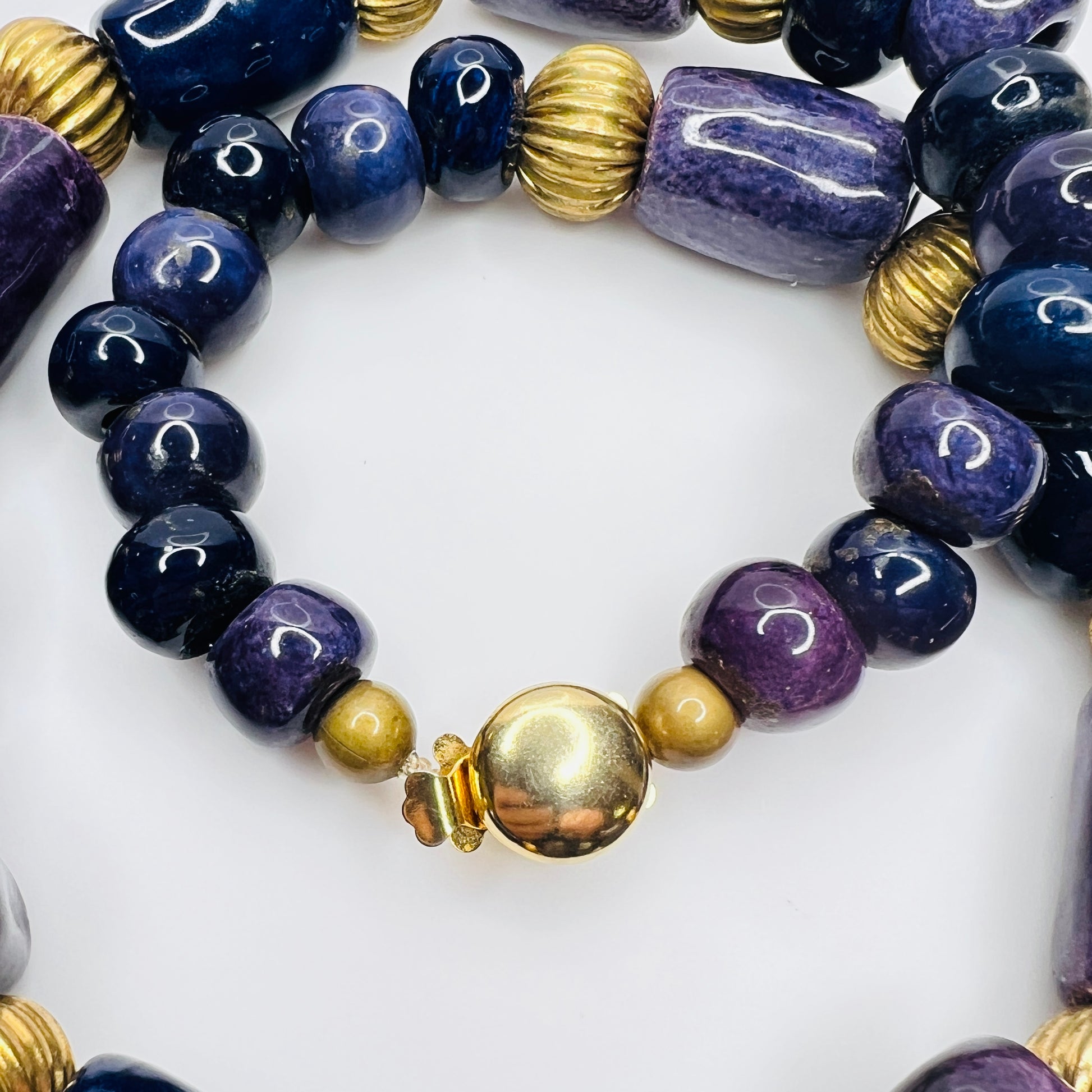Close-up of gold tone box clasp and glossy ceramic beads, 21 inch necklace
