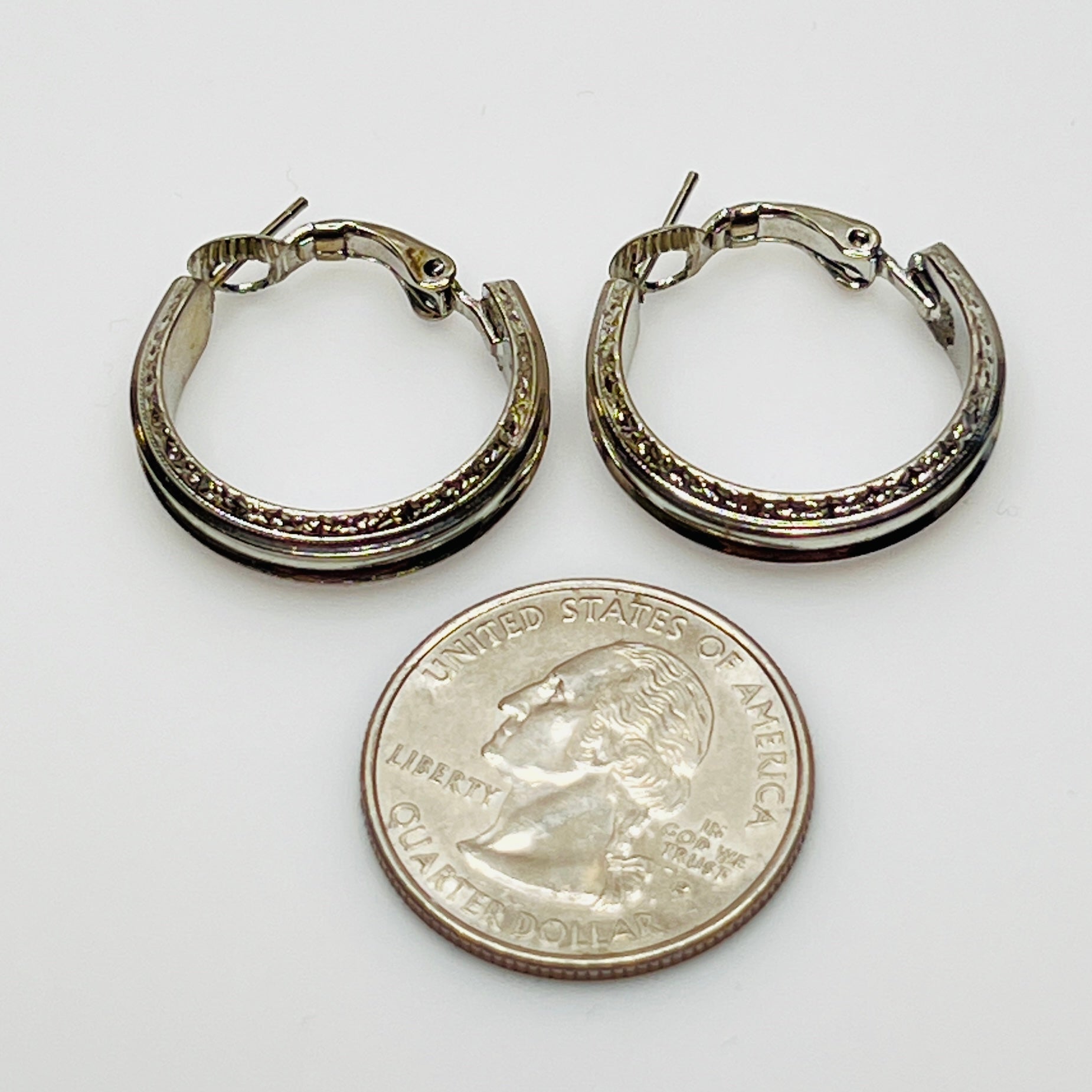 3/4 inch silver-tone hoops with etched detailing