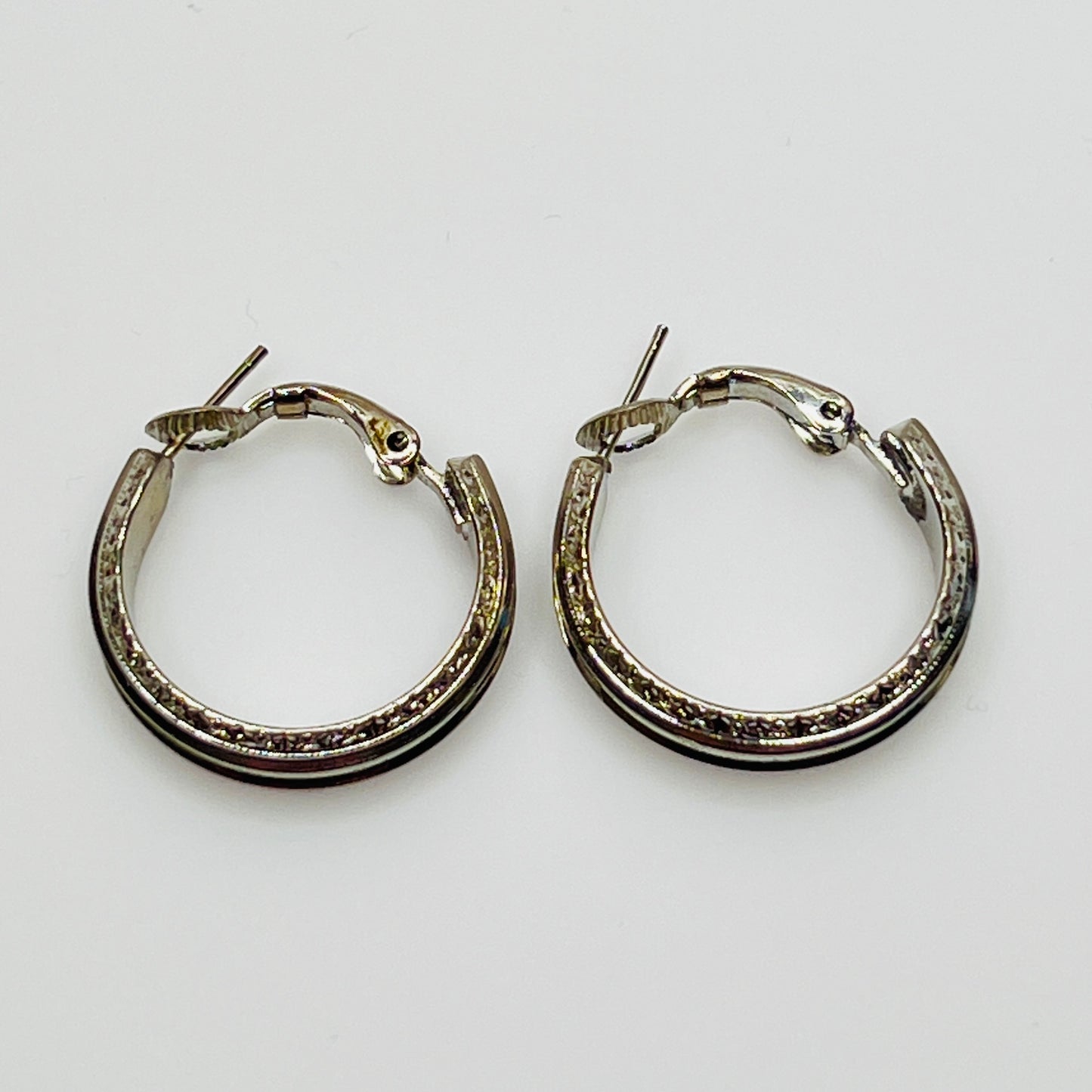 3/4 inch silver-tone hoops with etched detailing