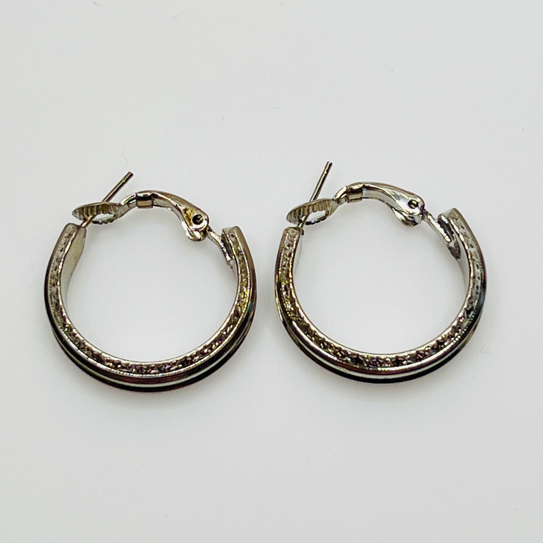 3/4 inch silver-tone hoops with etched detailing