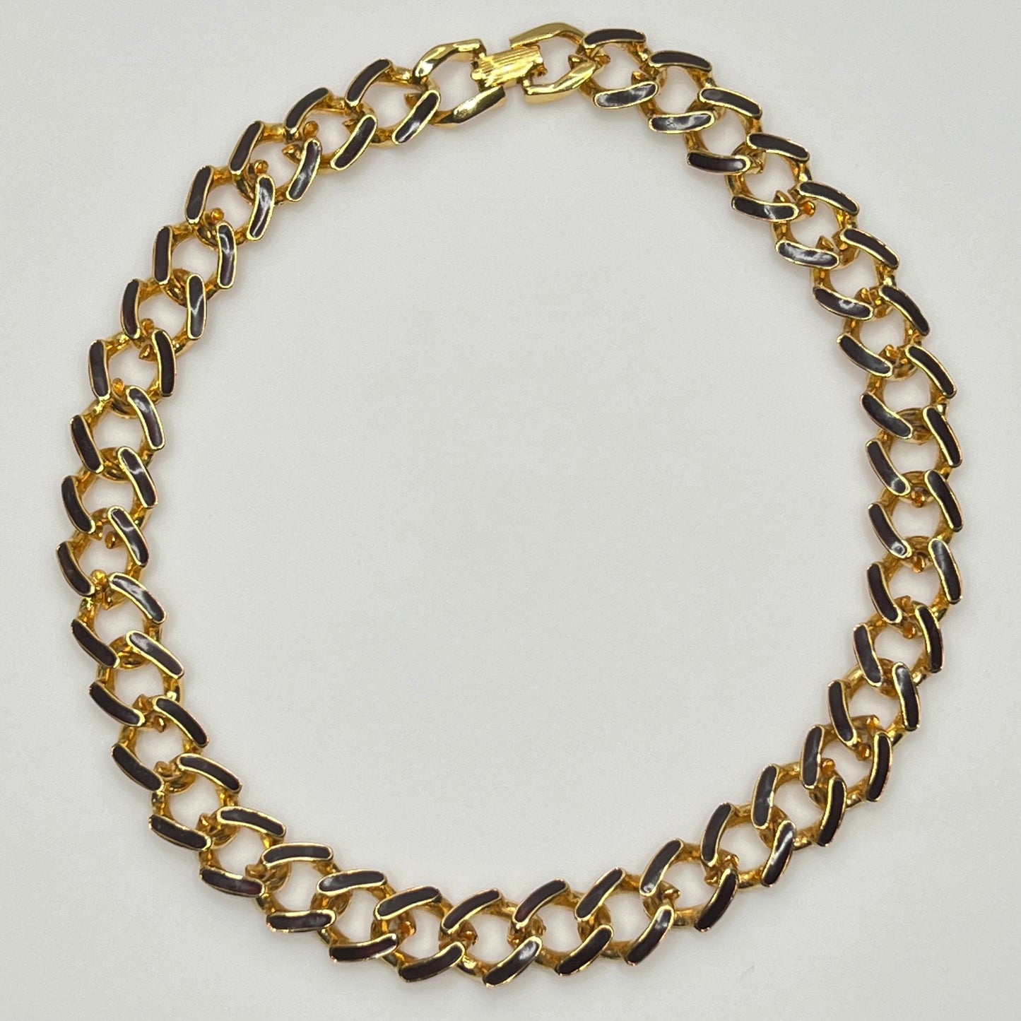1980s gold-tone chain necklace with brown enamel links and hinge clasp, collar length.