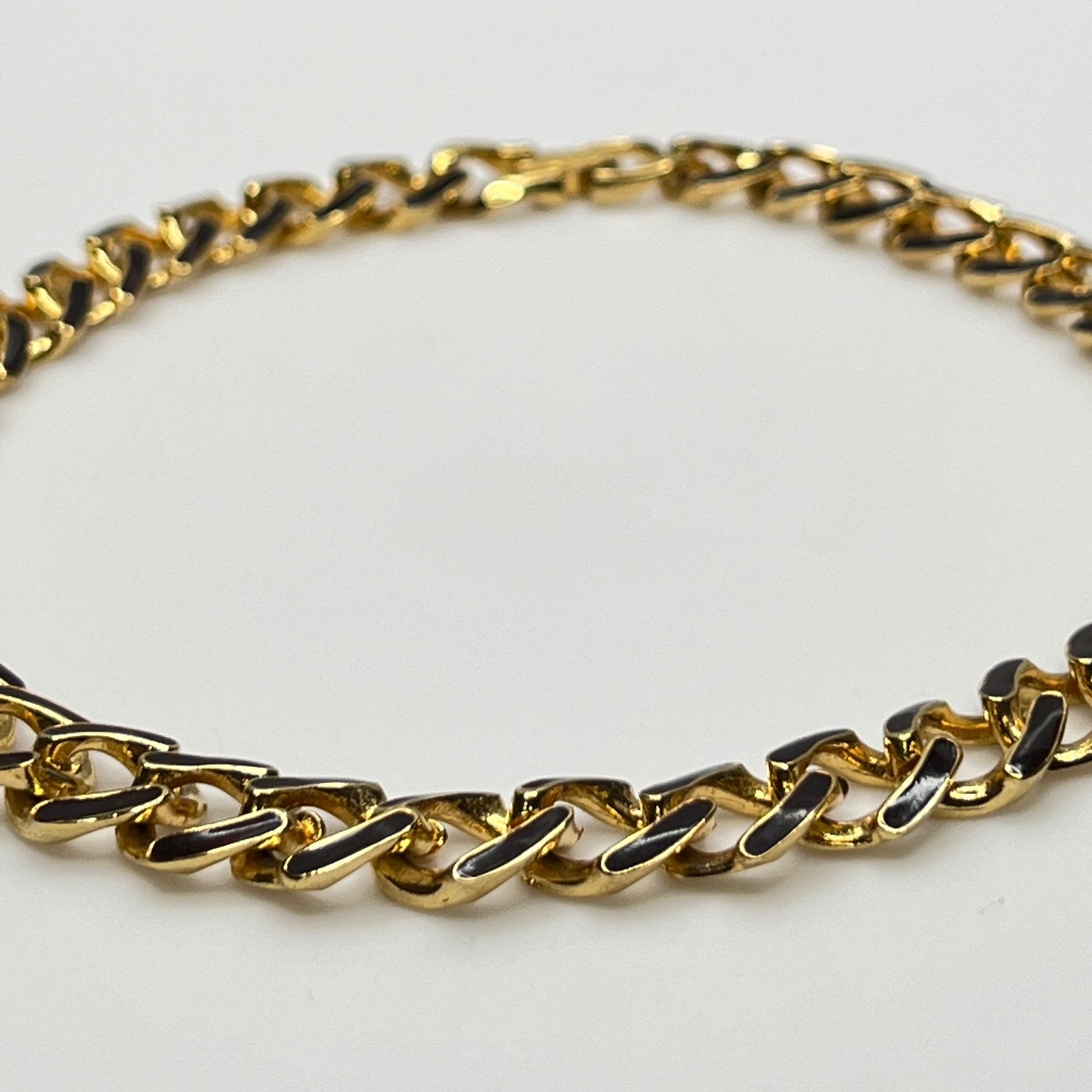 1980s gold-tone chain necklace with brown enamel links and hinge clasp, collar length.