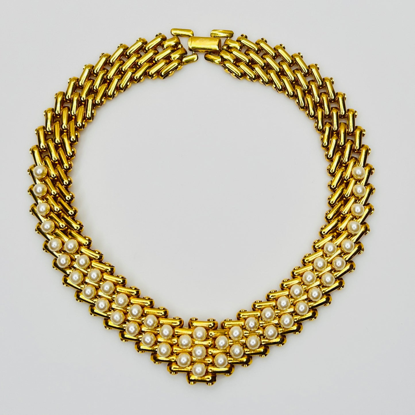 V-shaped gold-tone choker necklace with faux pearls in stacked link design