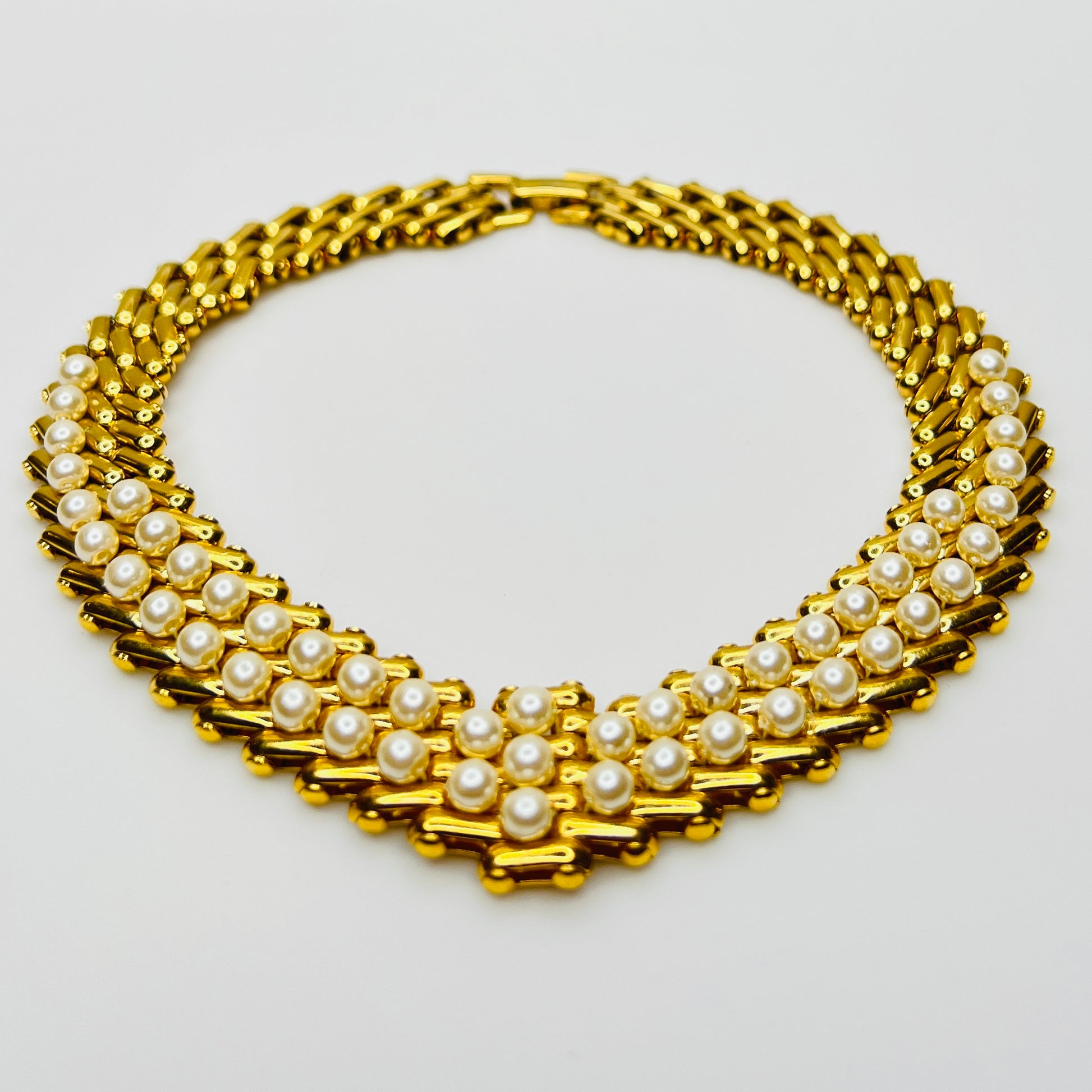 V-shaped gold-tone choker necklace with faux pearls in stacked link design