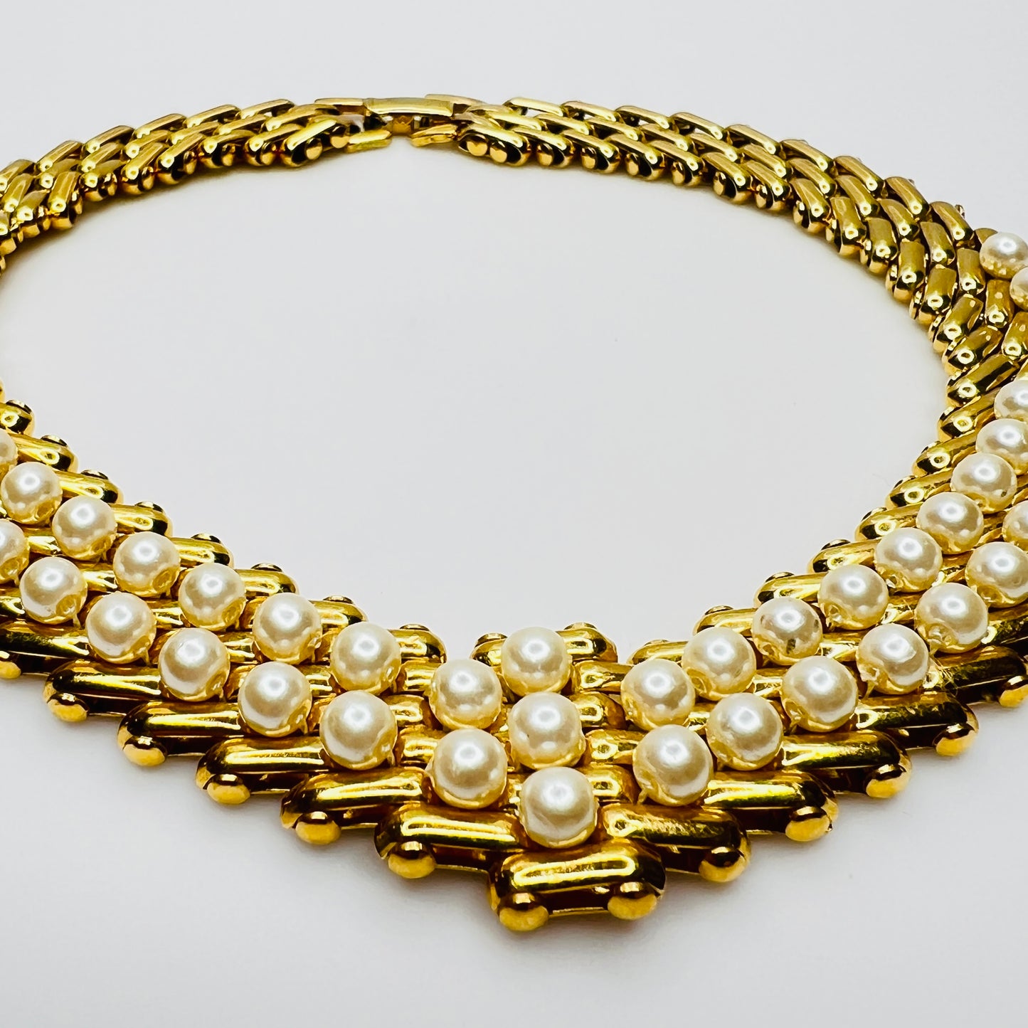 V-shaped gold-tone choker necklace with faux pearls in stacked link design