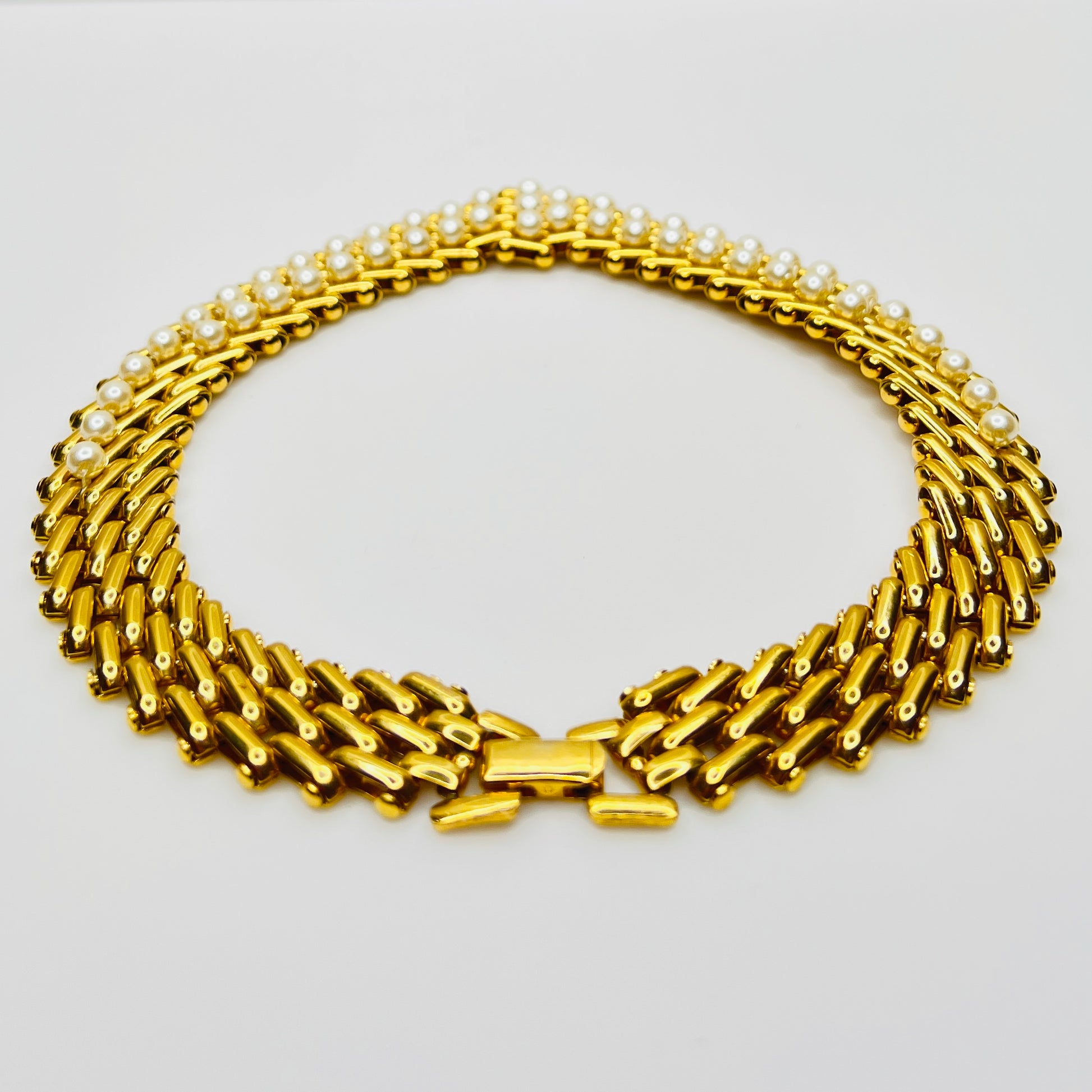 V-shaped gold-tone choker necklace with faux pearls in stacked link design